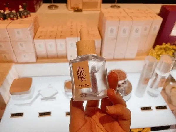 Hand holding BONNY & J Plareceta Ampoule in a cosmetic store display Hand holding BONNY & J Plareceta Ampoule in a cosmetic store display